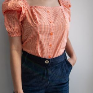 Orange Checkered Square Neck Puff Short Sleeve Top by Gorur Ghash. Fabric: Cotton. Price: ৳1000. Made in Bangladesh (BD). Buy the tops now!